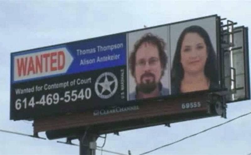 A wanted poster on a billboard asking for information regarding Tommy Thompson. 