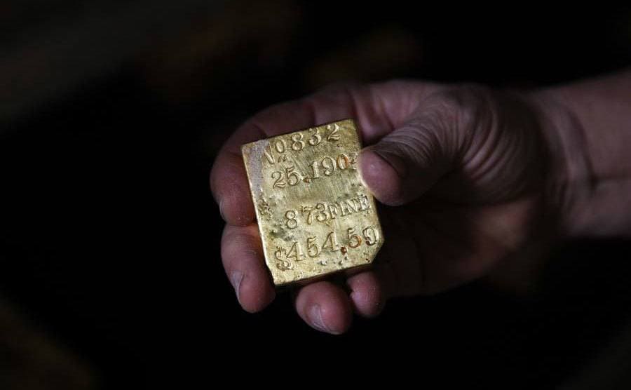 A piece of gold from the SS Central America held up for the camera. 