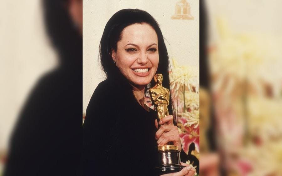 Angelina Jolie holding the Oscar she won for Best Supporting Actress 
