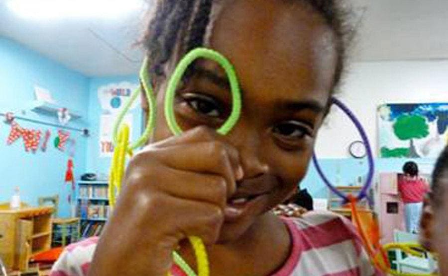 Relisha Rudd is playing with colorful pipe cleaners at an after-school program. 