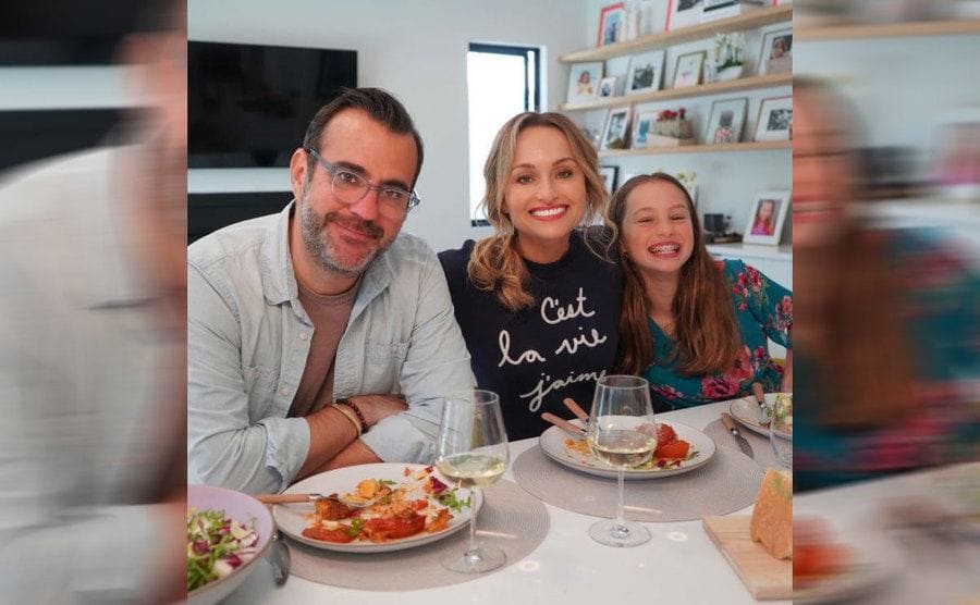 Shane, Giada, and Jade sitting at the dinner table together 