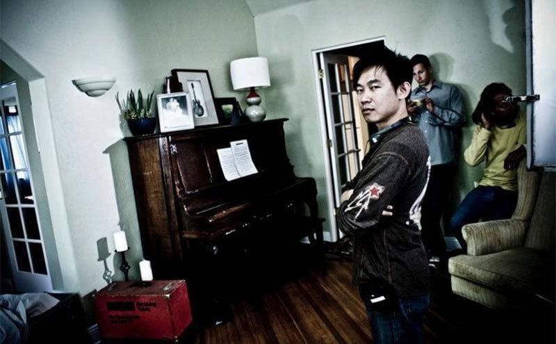 James Wan on the set of Insidious standing in the living room 