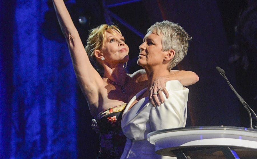 Melanie Griffith and Jamie Lee Curtis on stage at the Courage to Care event 
