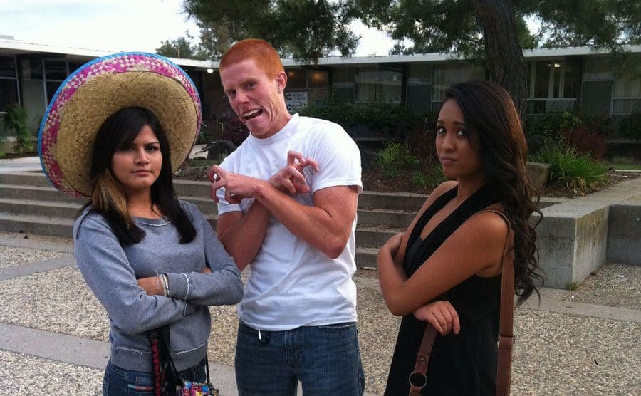 Bryce Laspisa is making a funny face and acting weird in a photo with two female friends. 