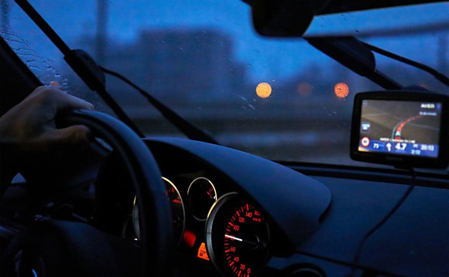 A driver steers as the GPS on the dashboard show’s the way home. 