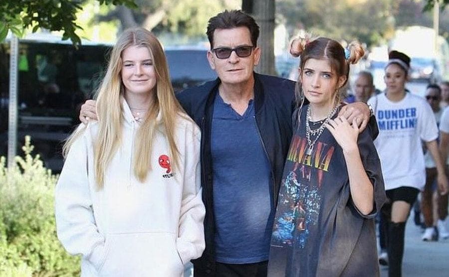 Charlie Sheen poses with his two teenage daughters. 
