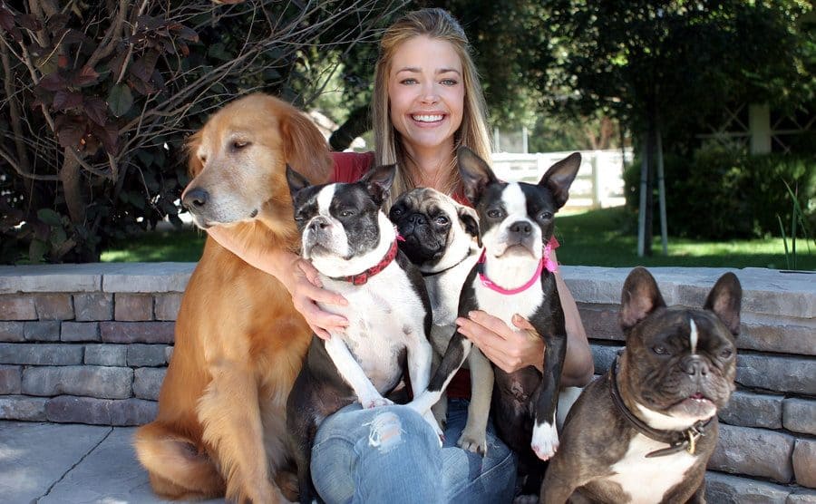 Denise Richards poses for a portrait with her dogs, Tina, Lucy, Henry, Terrier Stella, and Hank.