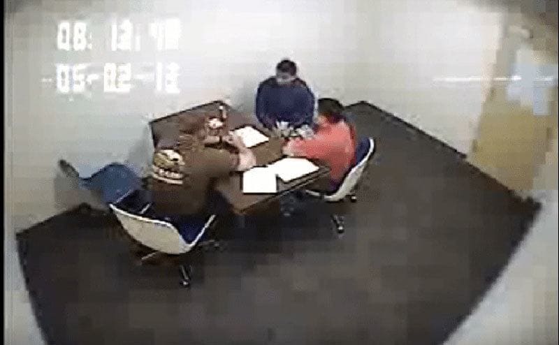 CCTV footage of police interrogating a suspect.