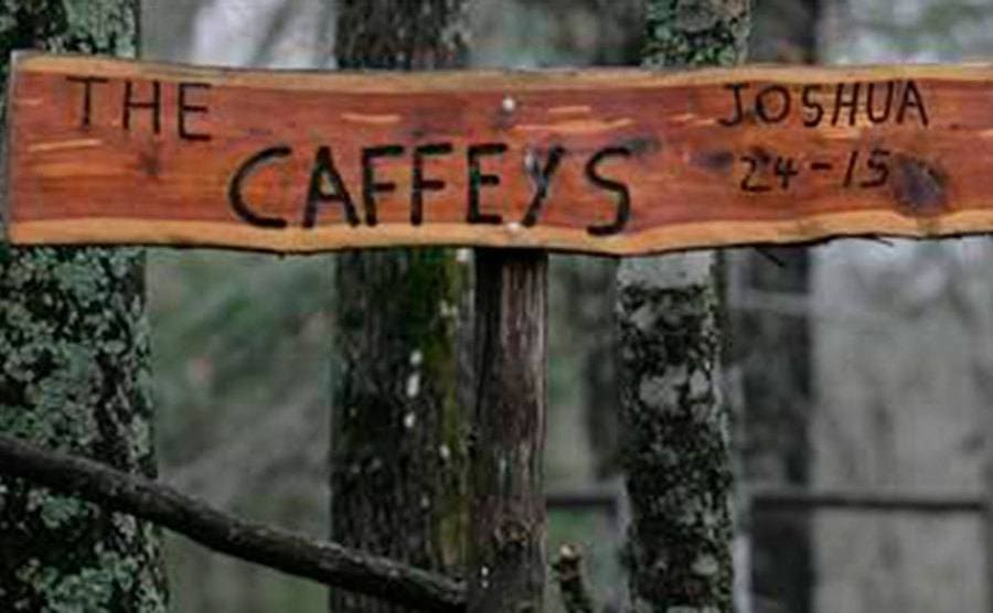 A wooden sign with the family name carved into it that hung outside the Caffey’s home. 