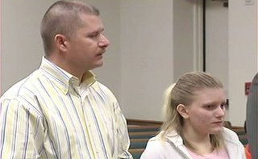 Terry Caffey is standing beside his daughter Erin in court. 