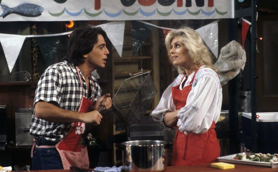 Judith Light and Tony Danza are arguing in a kitchen in a still from the show. 
