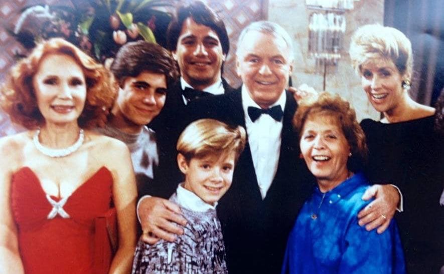 Frank Sinatra takes a group photo with the cast of ‘Who’s the Boss?”