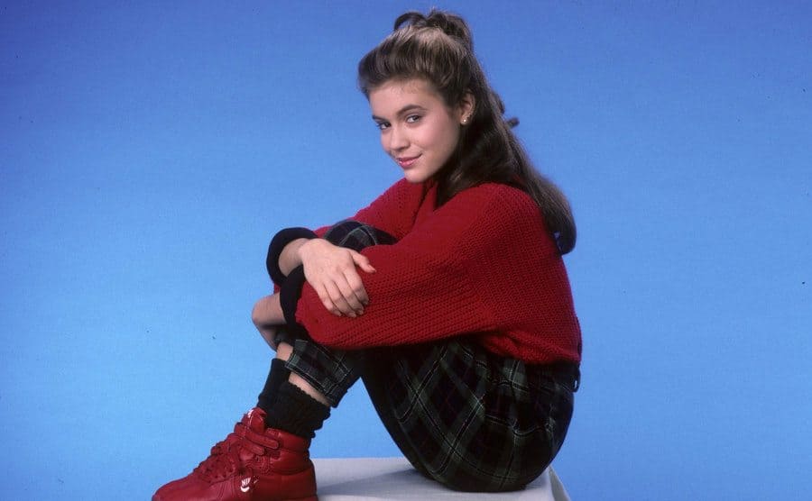 Alyssa Milano is posing for a promotional photo. 