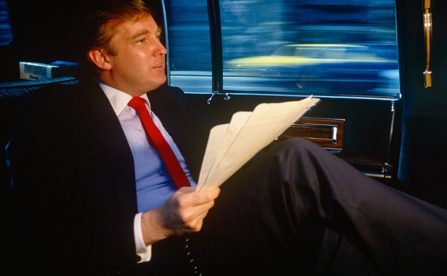Donald Trump on the backseat of a limousine.
