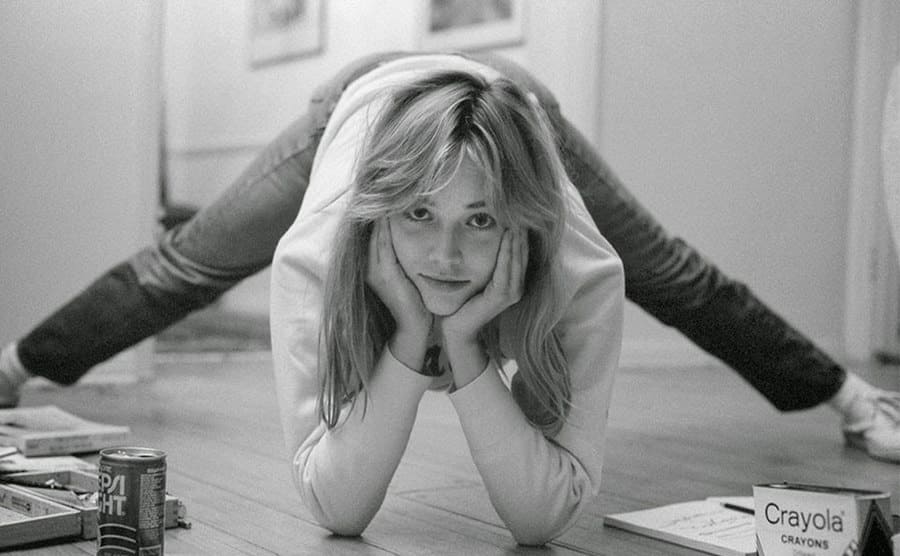 A young Sharon Stone in her teens is posing for a portrait at home.