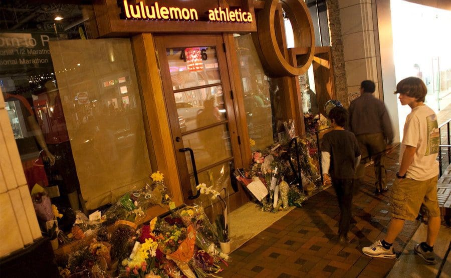 A vigil is held outside the Lululemon store. 
