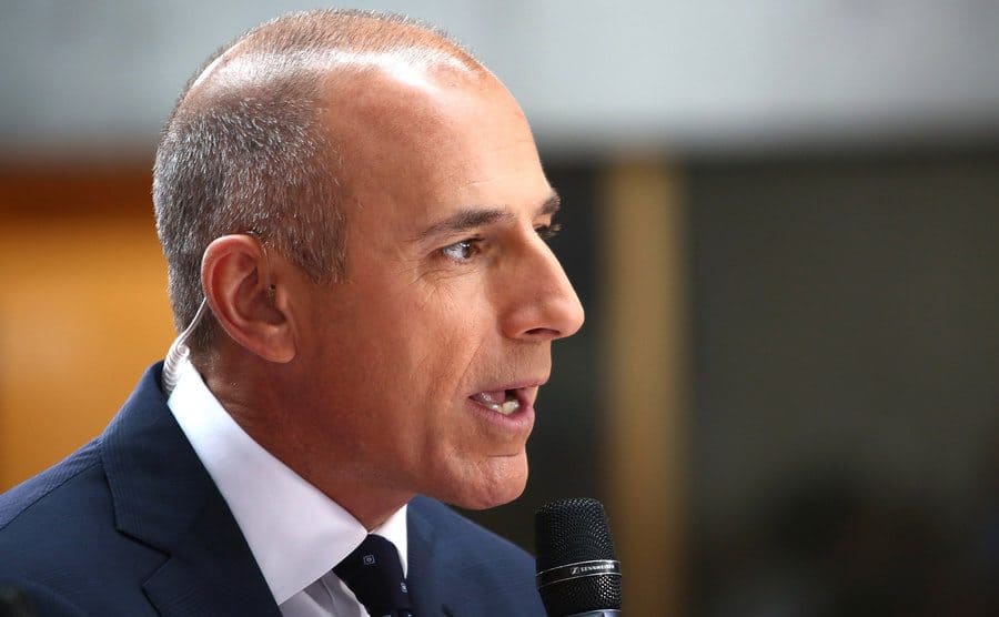 Matt Lauer is speaking on with a microphone. 