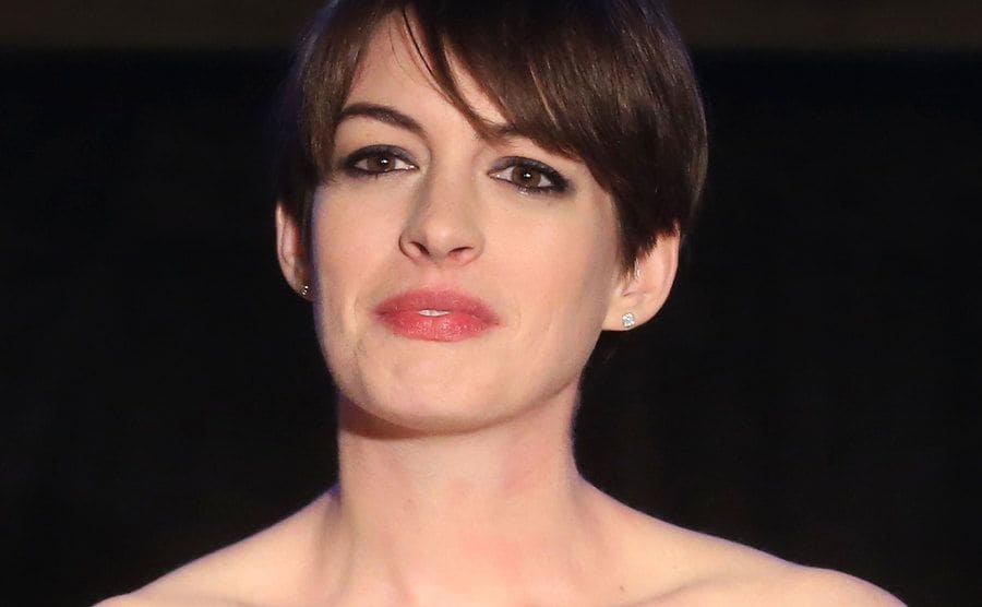 Anne Hathaway is wearing an indignation expression on her face.