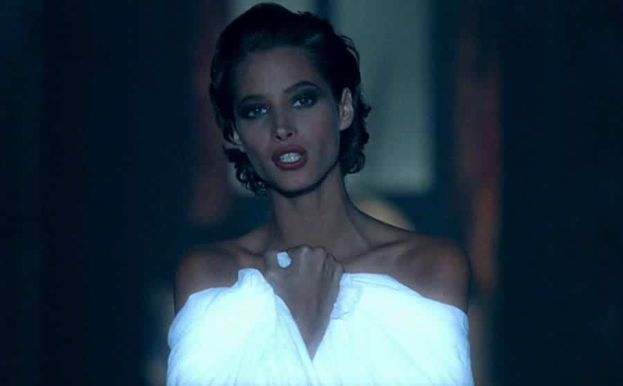 Turlington sings, wrapping herself in the white fabric in a still from Freedom. 