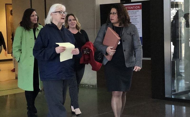 Marilyn Hartman talks to her attorney before exiting the courthouse.