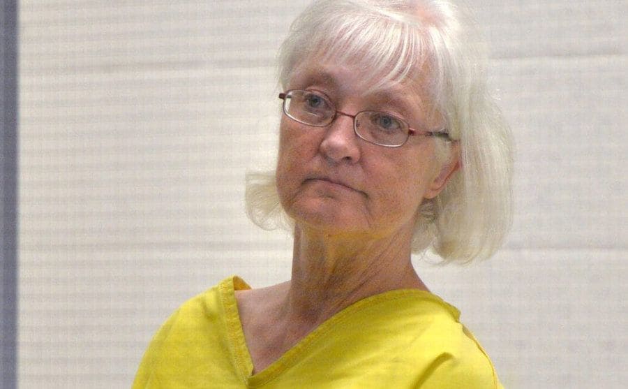 Marilyn Hartman sits at the police station after being arrested by the police. 