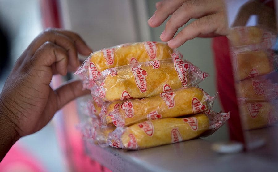 A customer reaches out to take a twinkie. 