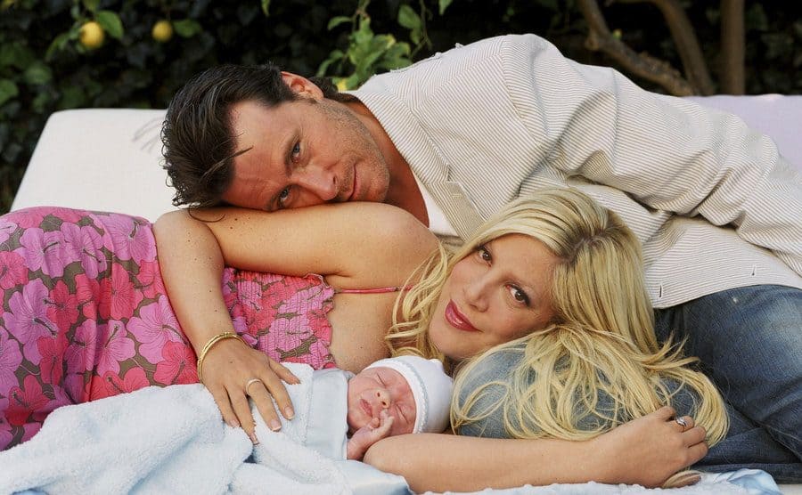 Dean McDermott, Tori Spelling, and their baby boy Liam Aaron pose for a portrait.