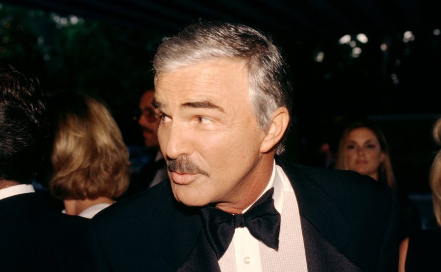 A portrait of Burt Reynolds attending an event. 
