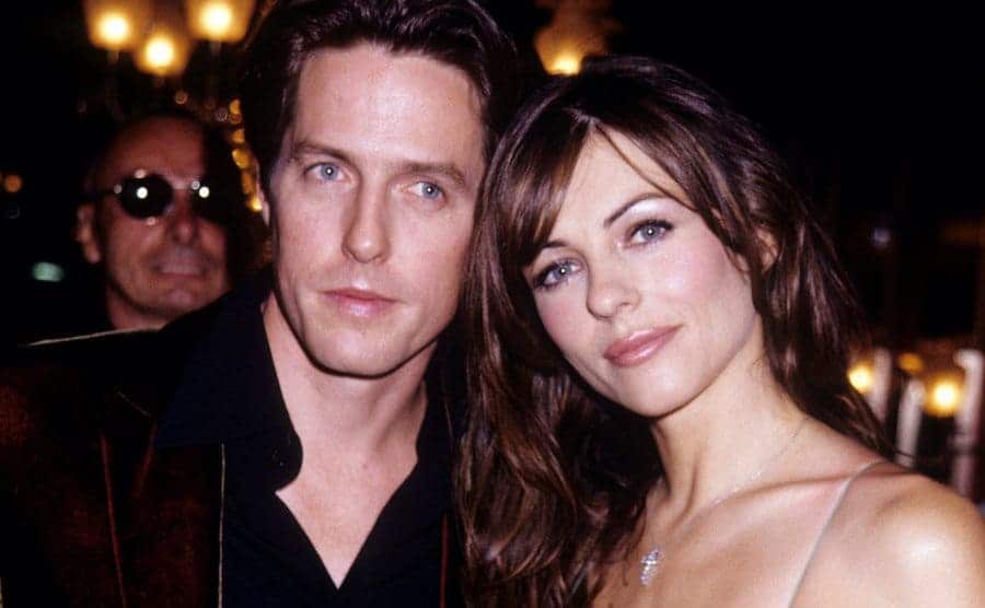 Hugh Grant and Hurley attend an event. 