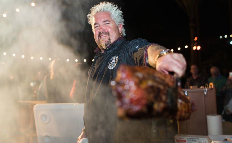 Guy Fieri cooks on the grill. 
