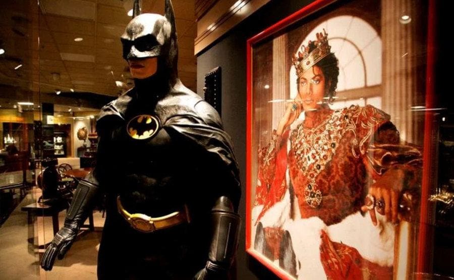 The original Bat-suit stands next to a framed picture of Michael Jackson.