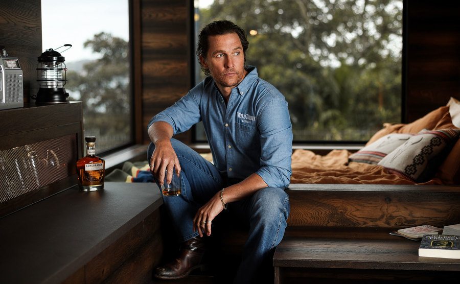 Matthew McConaughey is sitting in a bedroom in a cabin. 