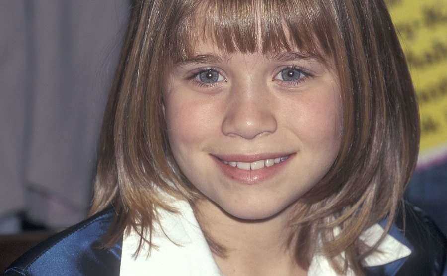Young child Mary-Kate Olsen poses for the press.