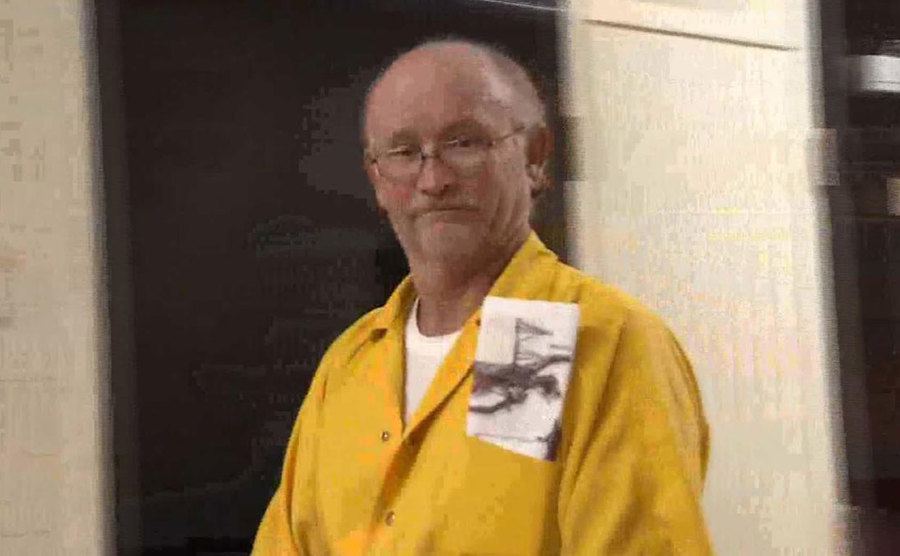 Carl stands outside the courtroom after his arrest.