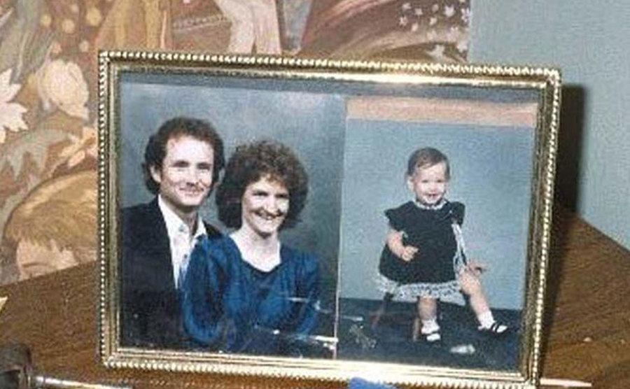 A framed picture of Carl, Tracey, and Carolyn on a desk.