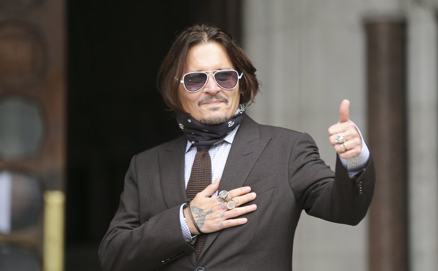 Depp greets his fans as he arrives at court.
