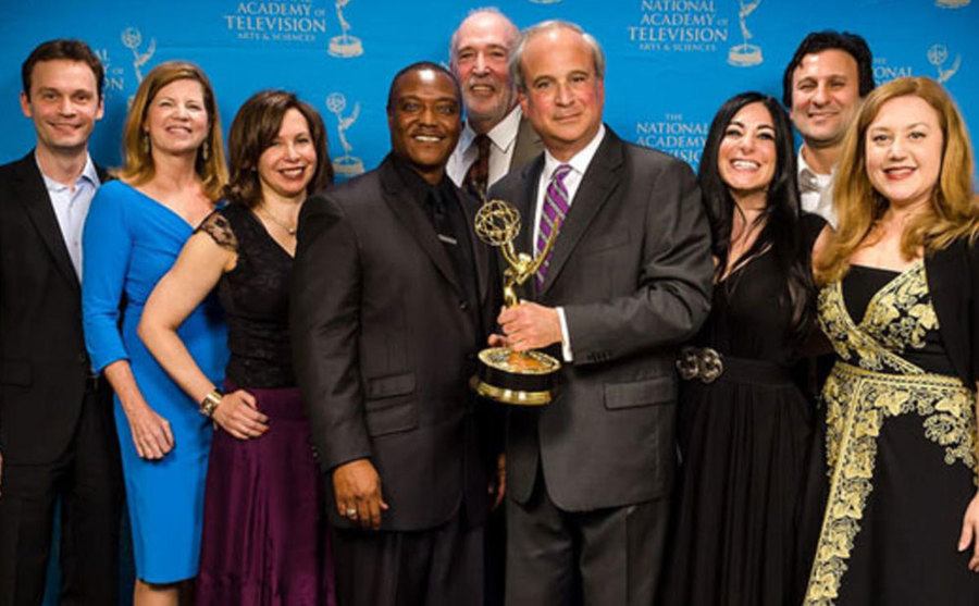 The cast of 48 Hours poses backstage at the Emmy Awards.