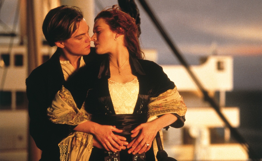Leonardo DiCaprio and Kate Winslet stand on the deck of the Titanic. 