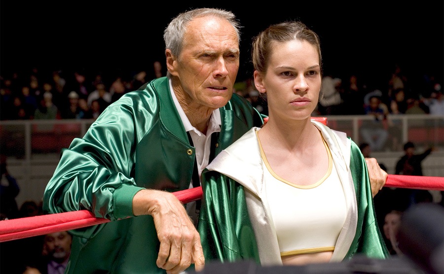 Hilary Swank and Clint Eastwood are standing on the side of the boxing ring. 