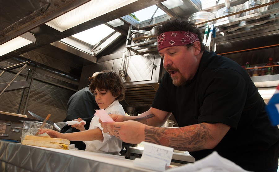 Jon Favreau and Emjay Anthony prepare food in their food truck in the film. 