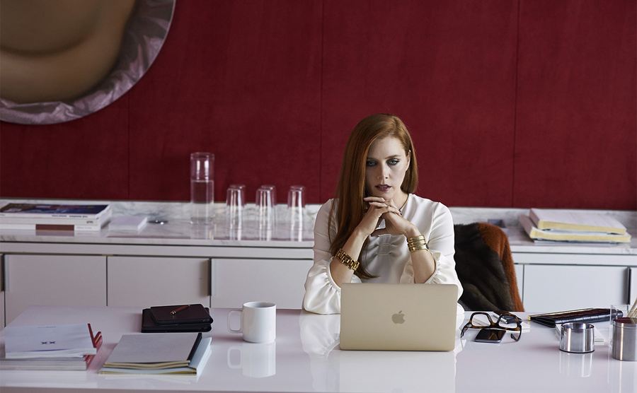Amy Adams, as Susan Morrow, sits in her office. 