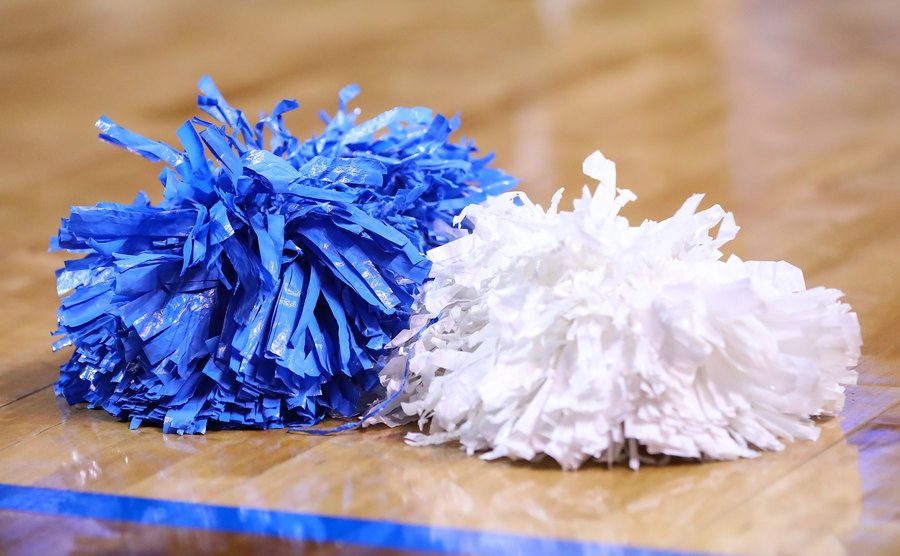 A photo of cheerleaders’ pompoms on the court.