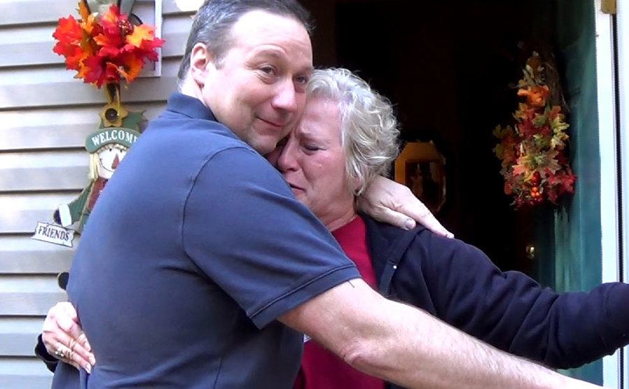 David embraces his mother as he arrives home.
