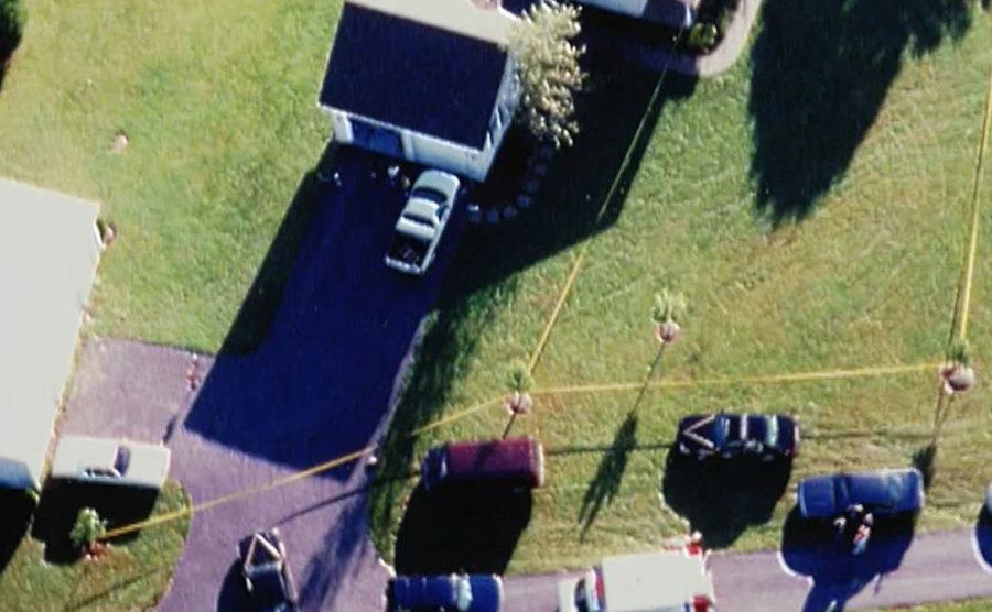 An aerial view of police surrounding the Camm family house.