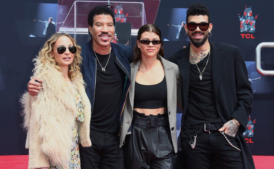 Nicole Richie, Lionel Richie, Sofia Richie, and Miles Richie attend an event.