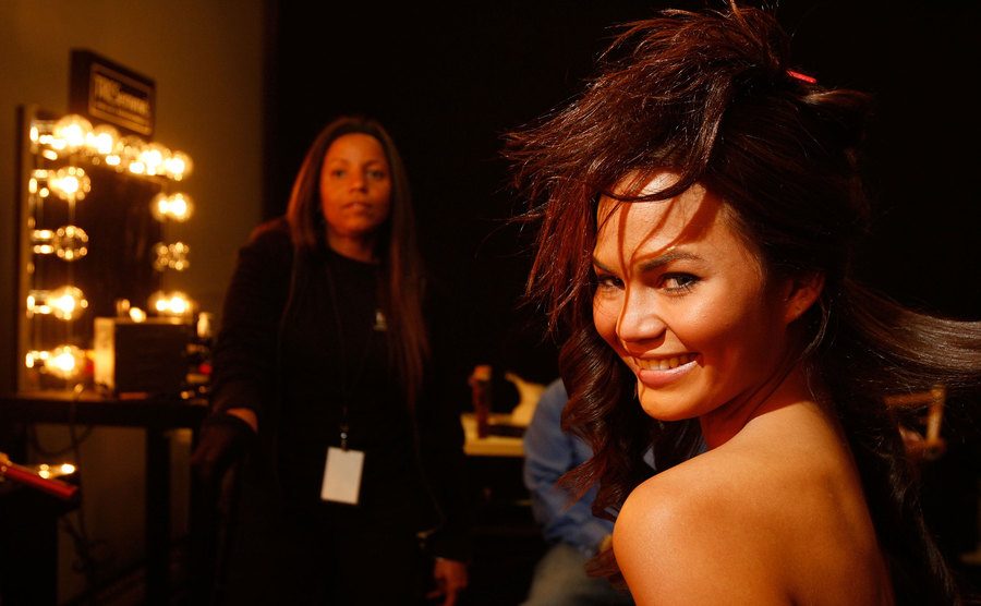 Teigen is touched up backstage to a show.