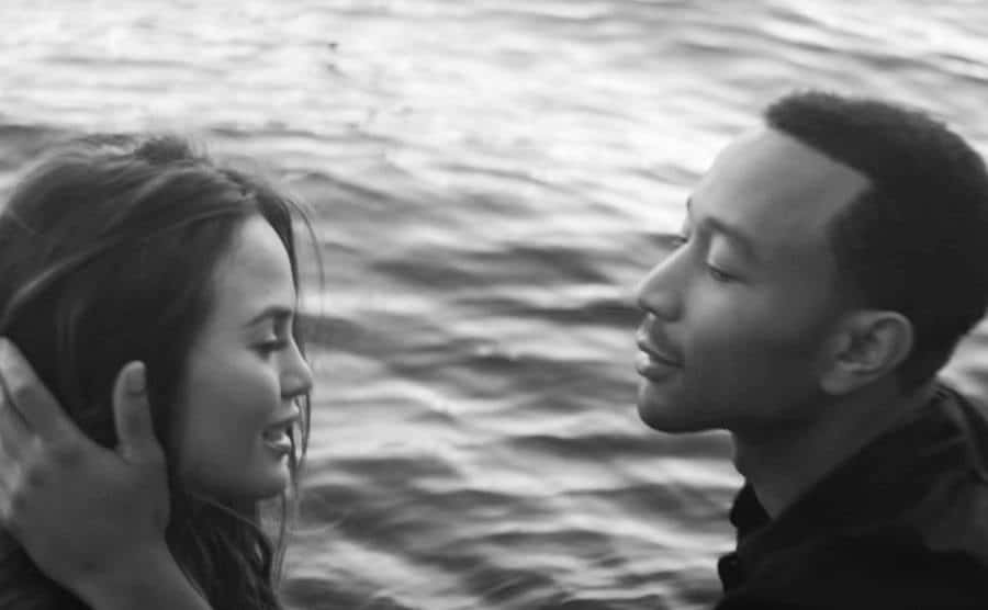 Chrissy Teigen and John Legend are in a still from Legend’s music video.