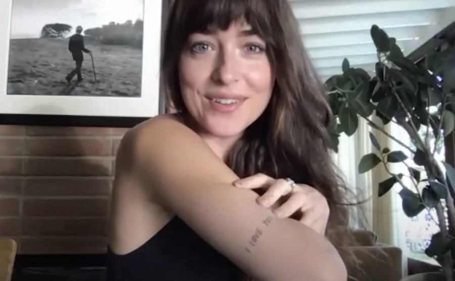 A still of Dakota showing her tattoos.
