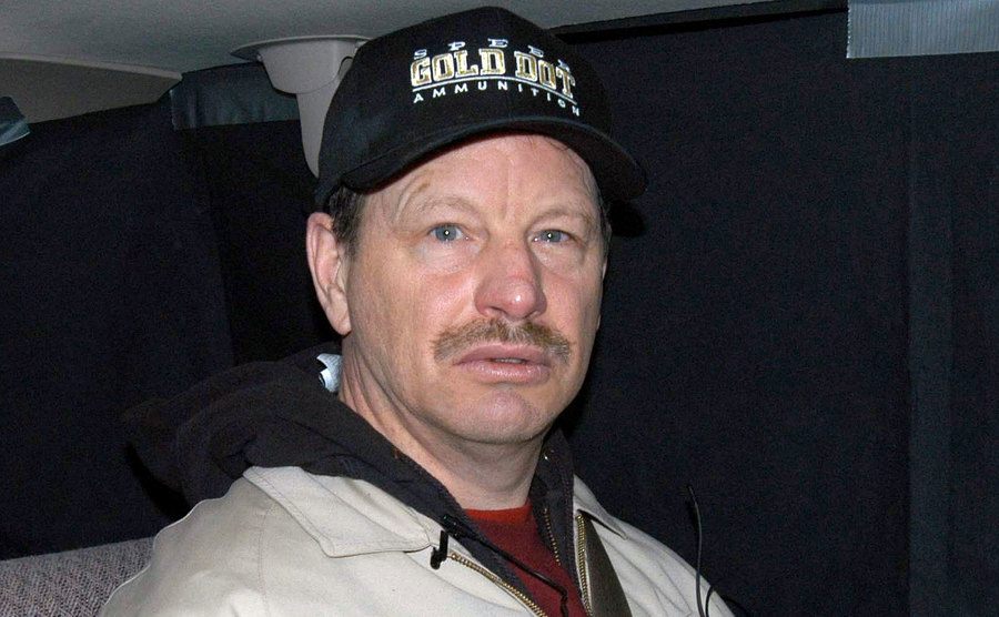 Gary Ridgway sits in the backseat of the investigator's car.