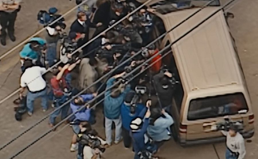 A photo of the press arriving at the mass suicide scene.